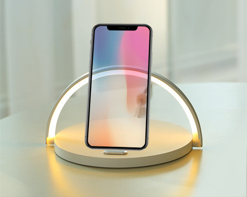 Person using a smartphone on a wireless charging pad with a white background